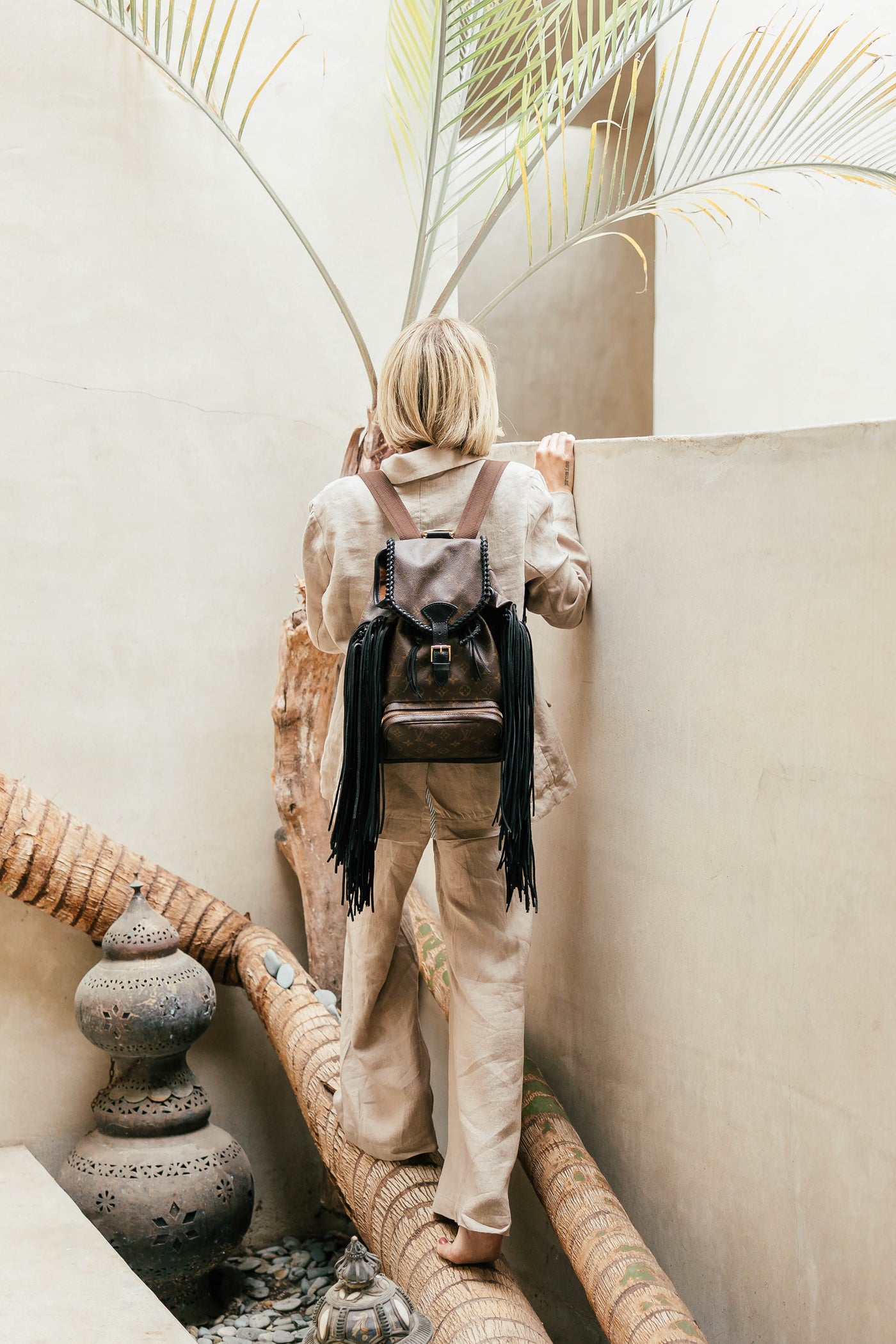 a backpack or a worn-in leather bag perhaps with fringe Backpack